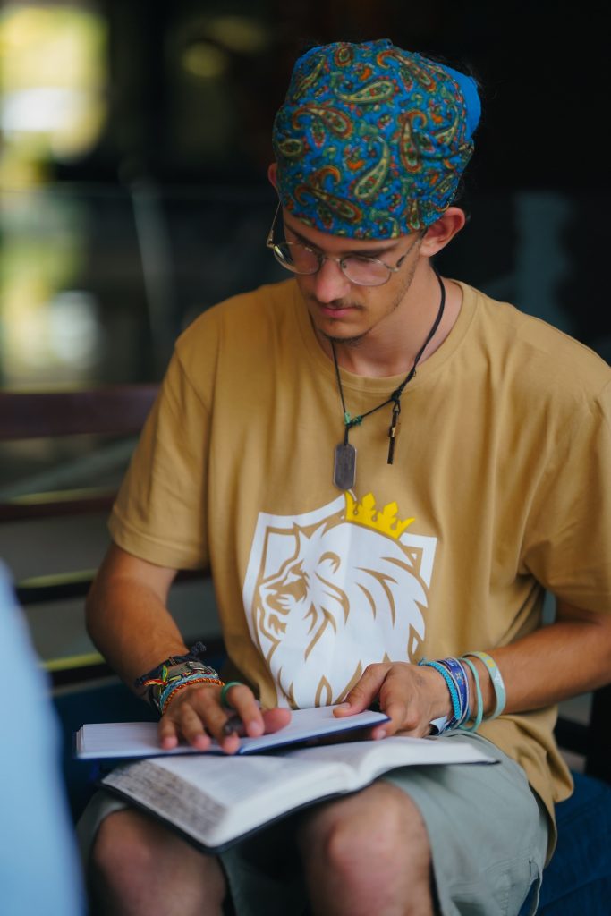 student with open Bible, studying, exploring